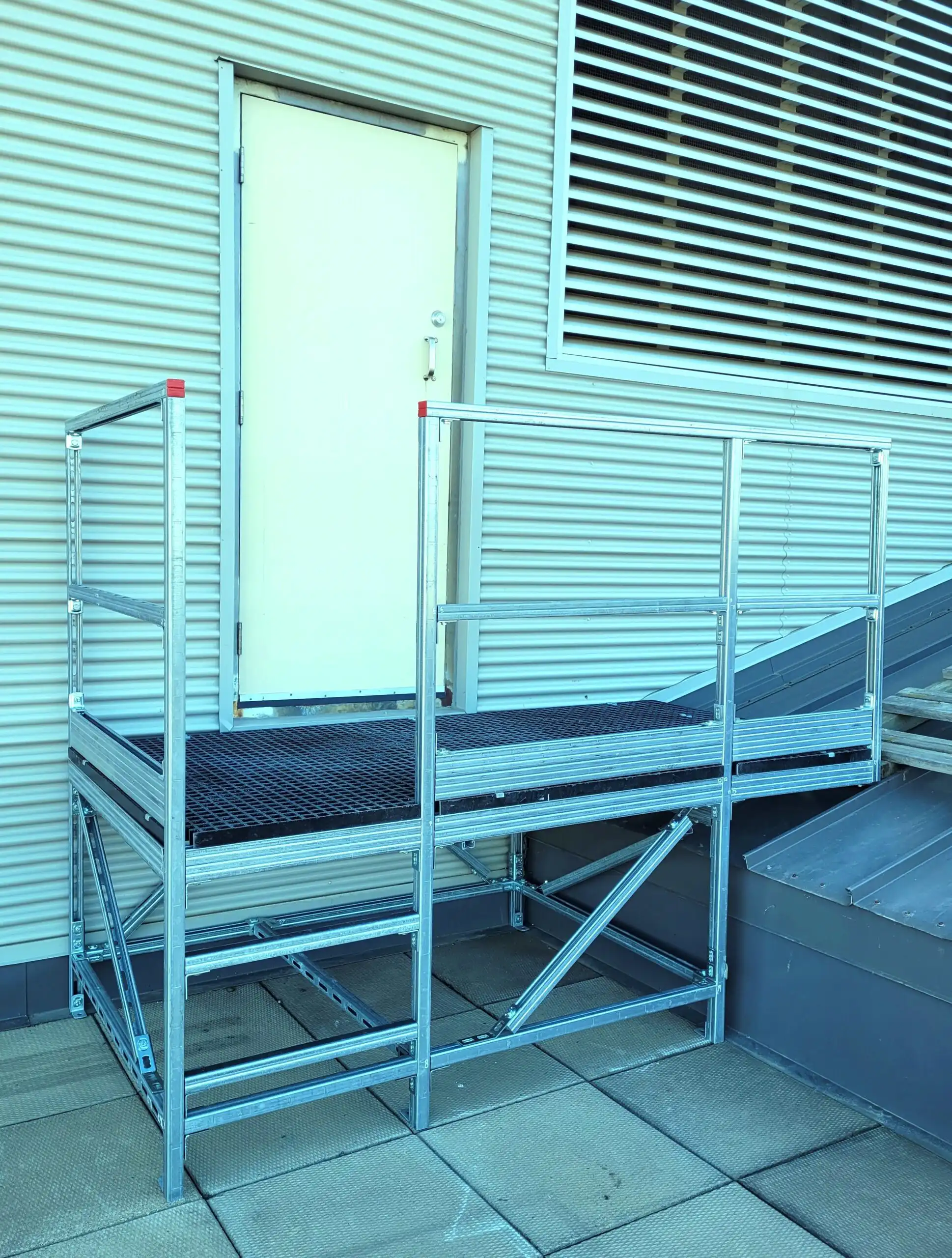 Mechano Max rooftop access platform with safety handrails installed on industrial facility